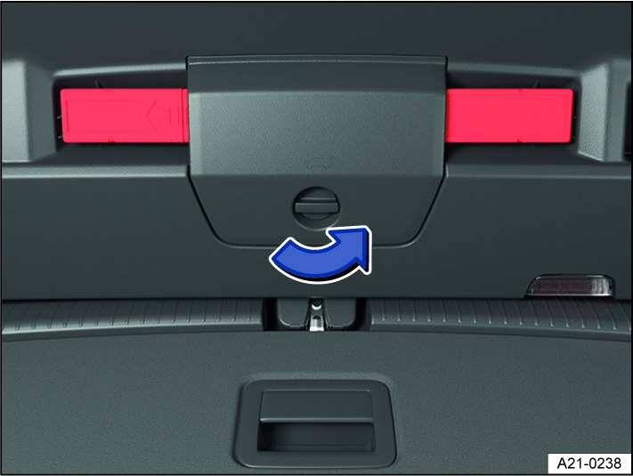 Fig. 64 In the trunk lid: open the holder for the warning triangle.